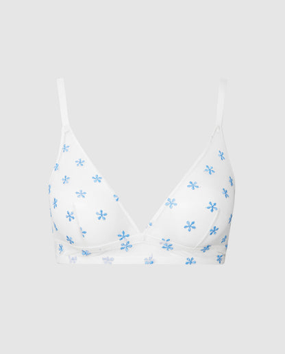 An mesh triangle bralette in white with blue flowers.