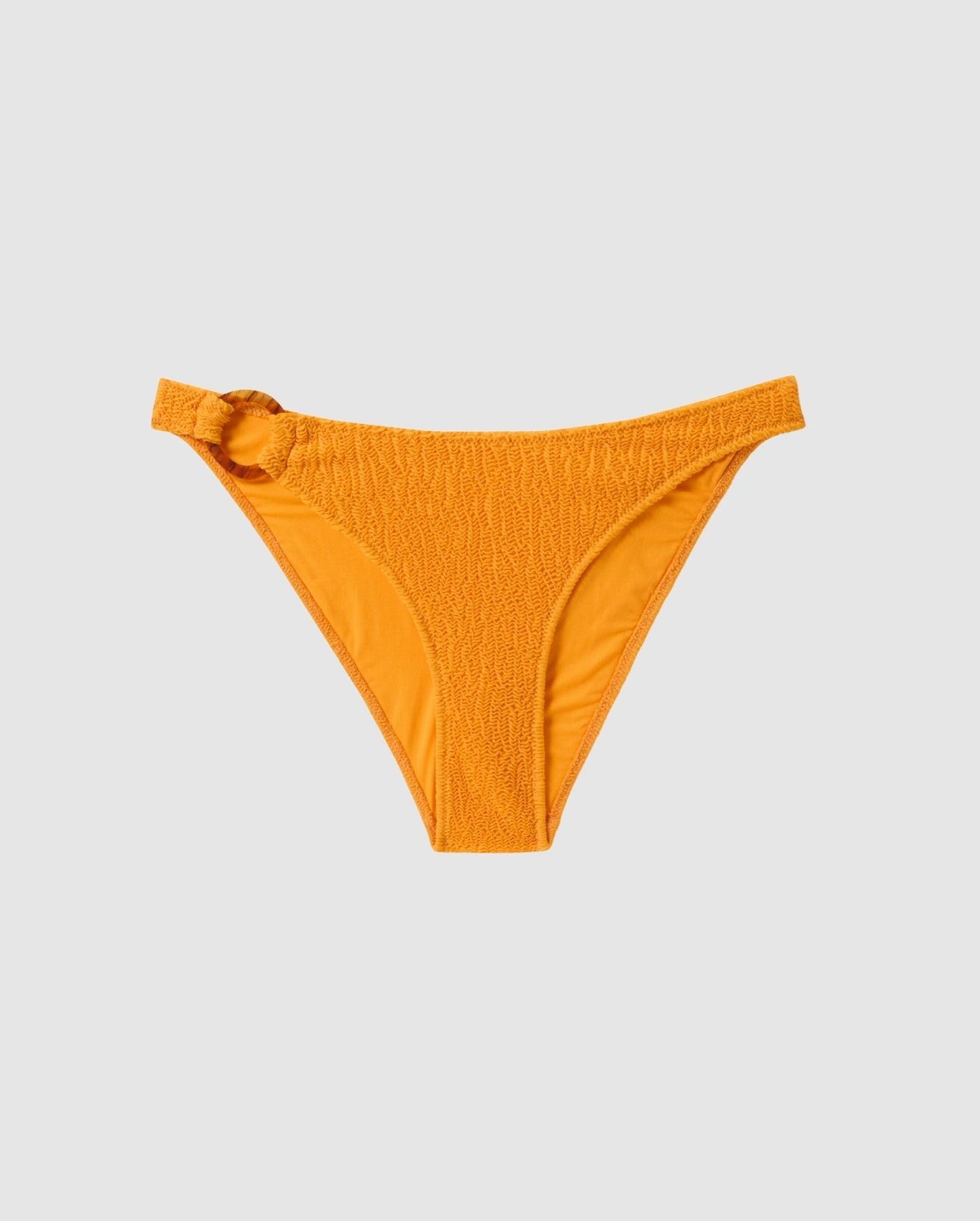 An bikini bottom in apricot orange with a ring design. 