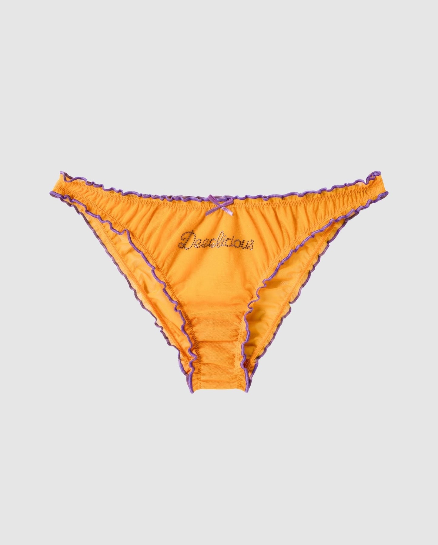 An ruffled mesh bikini brief in a mustard orange with lilac accessories.