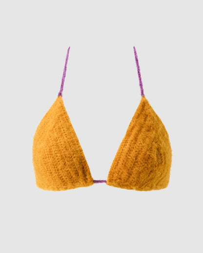 An knitted triangle bralette in mustard color.