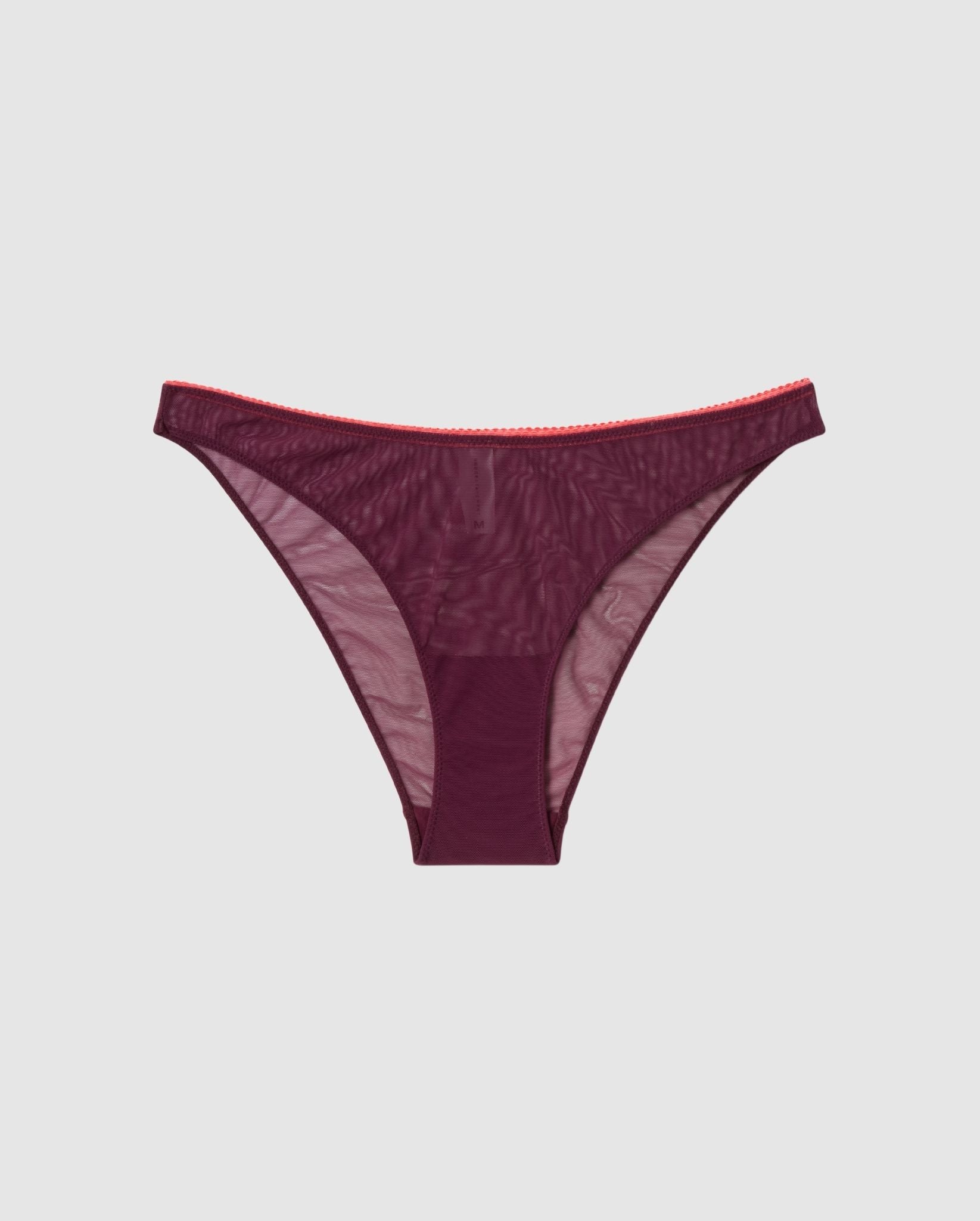 An mesh bikini brief in cherry with coral accessories.