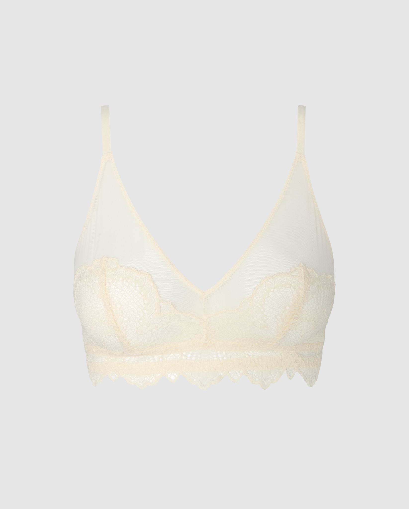 An lace triangle bralette in cream white with mesh accessories.