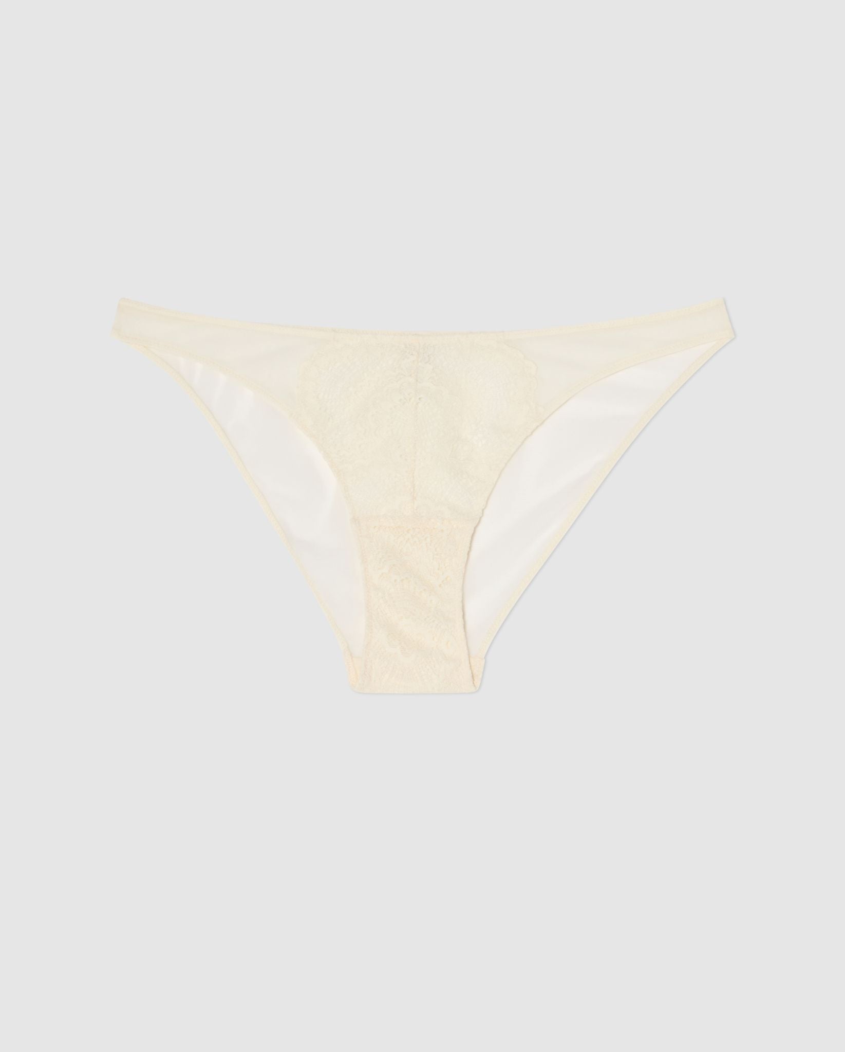 An mesh bikini brief with lace accessories in cream white.