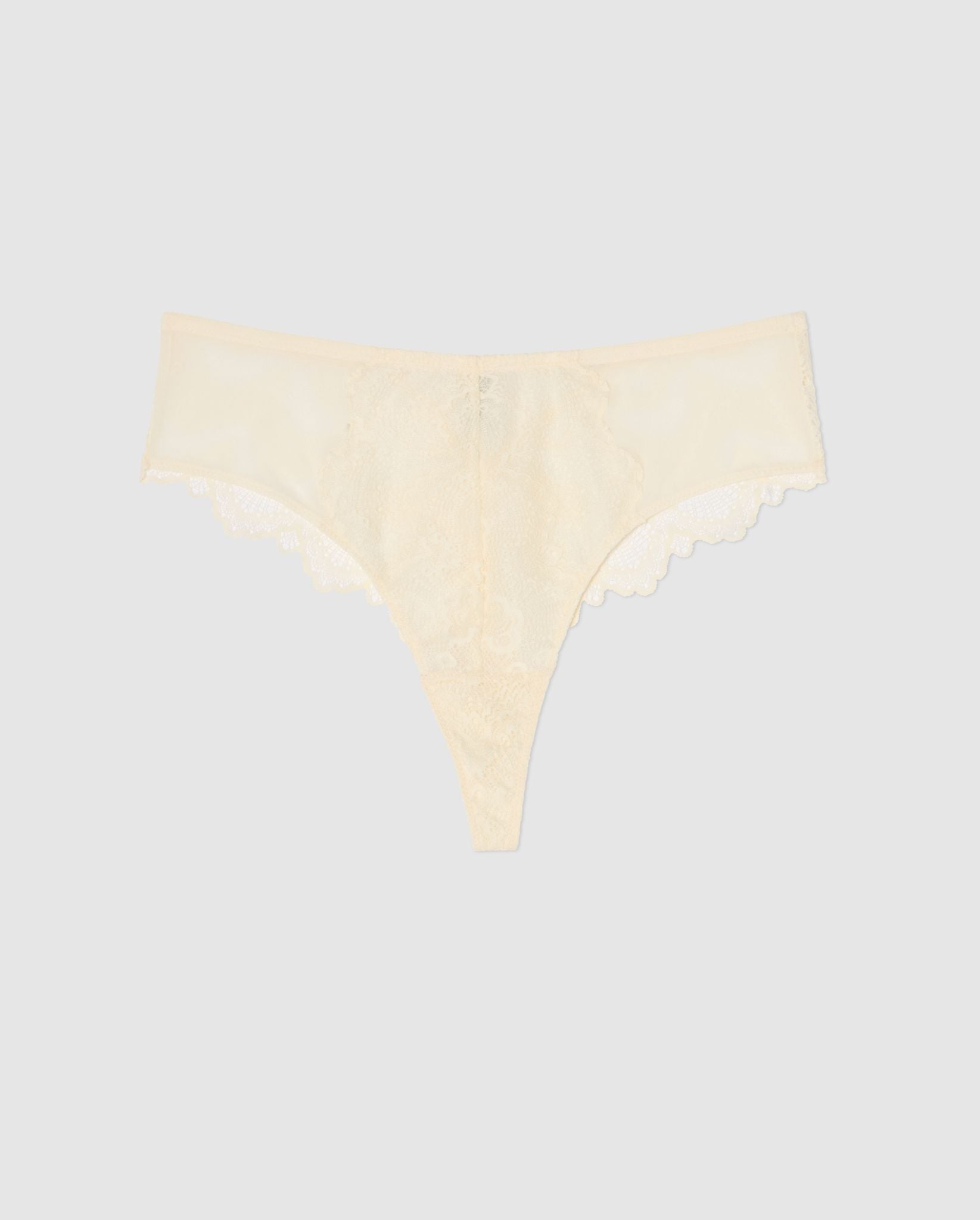 An mesh highwaist high cut pantie in cream with lace accessories.