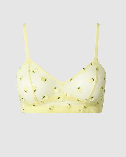 An mesh balconette in a light yellow with citrus accessories.