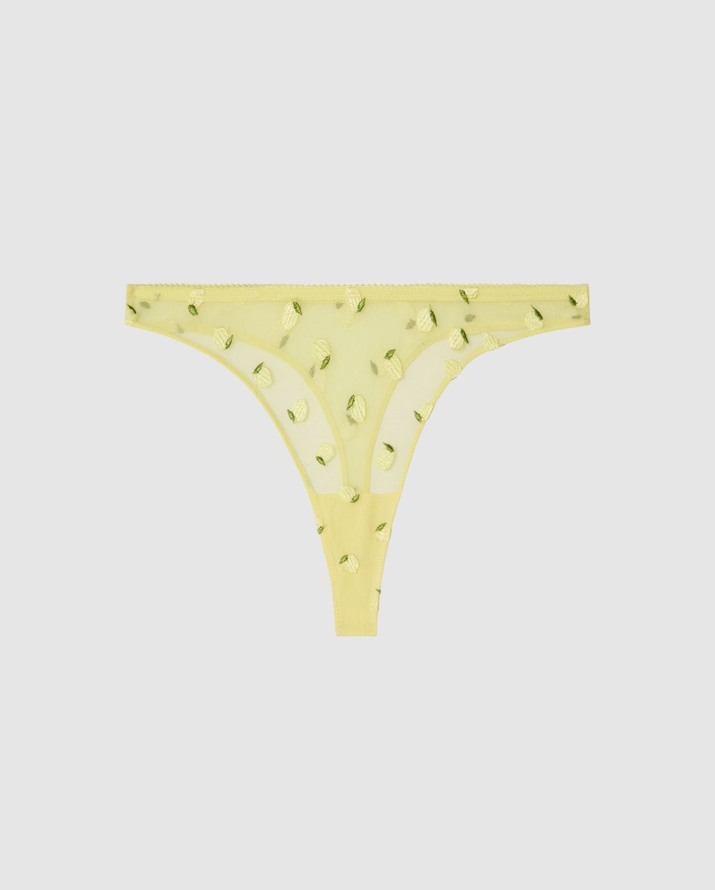 An mid rise high cut panty in light yellow mesh with lemon accessories.