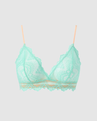 An lace triangle bralette in turquoise with peach accessories.